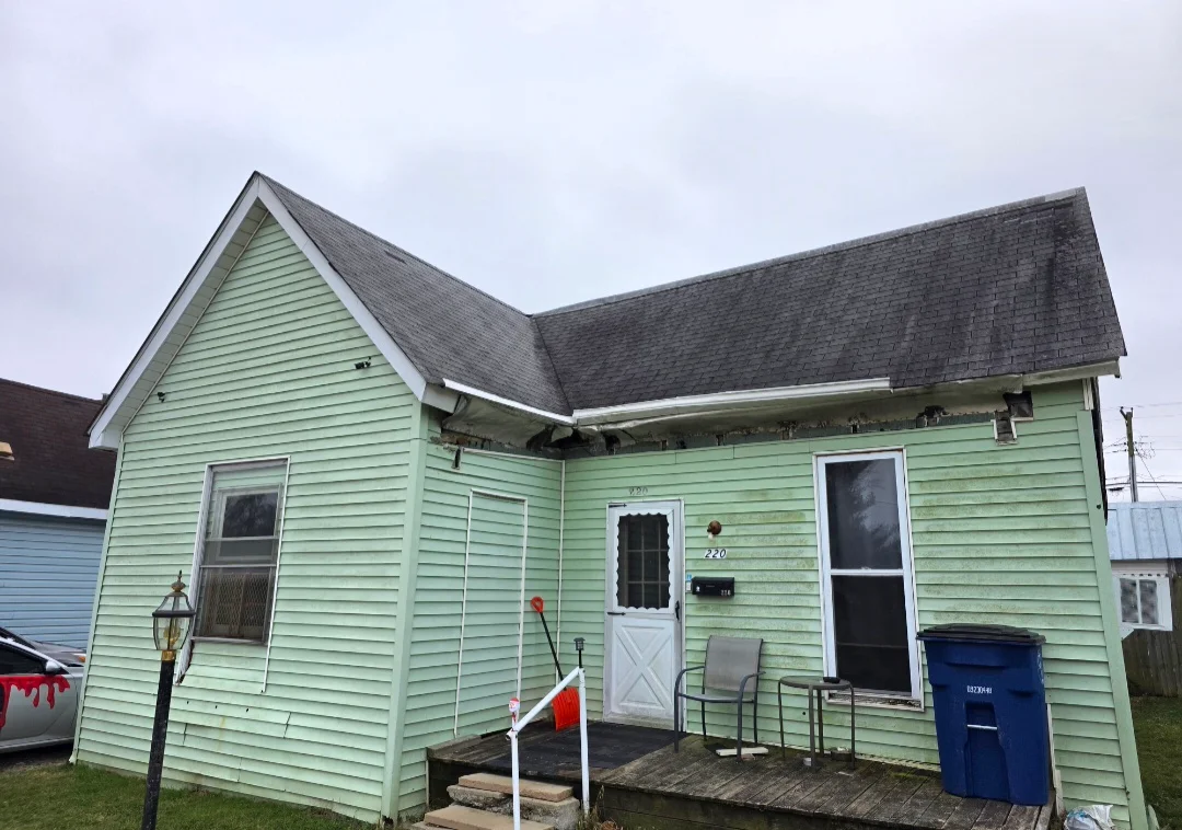New asphalt shingle roof installed on residential home with gable and pitched roof sections