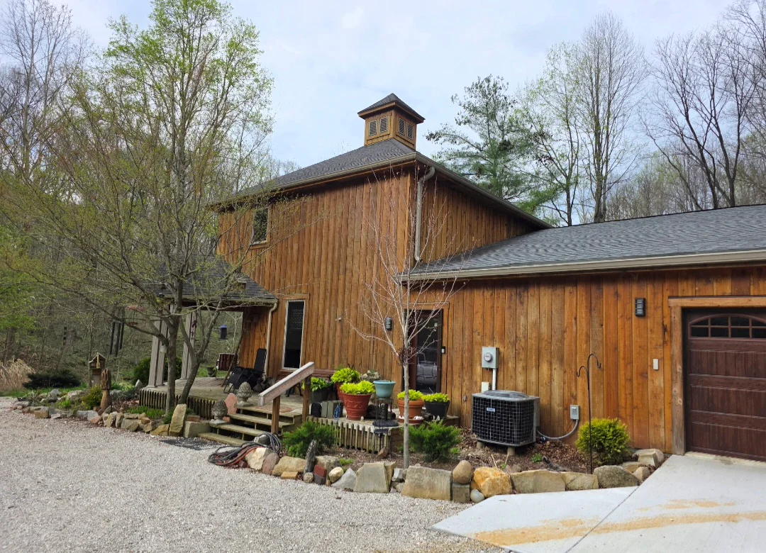 Barn-style home with new asphalt shingle roof, cupola, and wood siding exterior