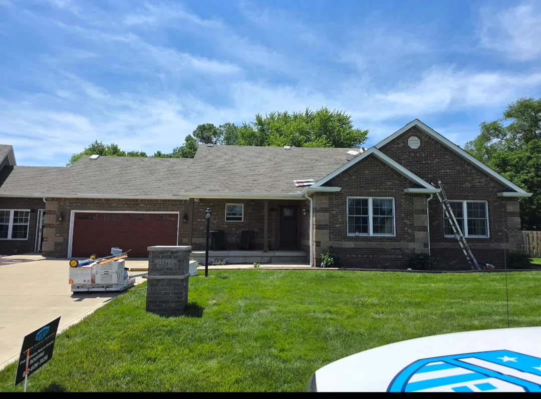 New asphalt shingle roof installation on brick residential home with gray shingles