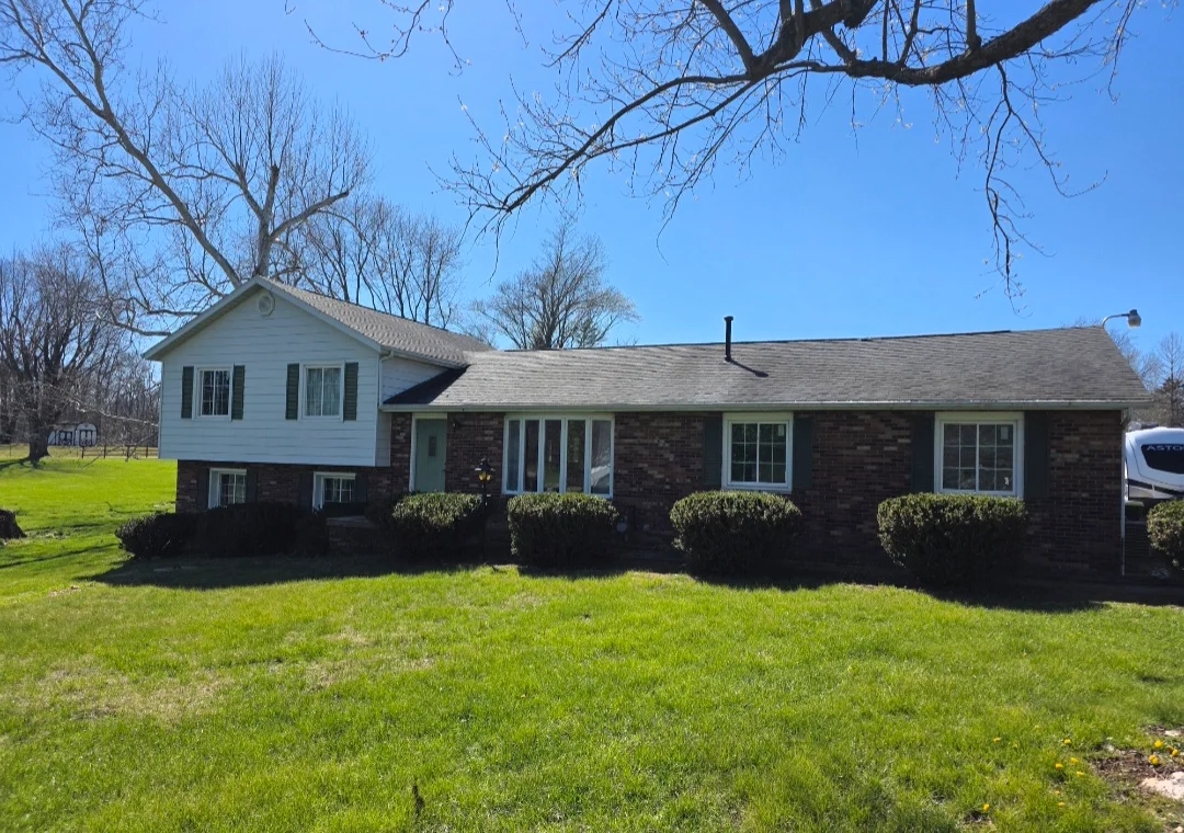 New asphalt shingle roof on brick and vinyl split-level home with proper ventilation