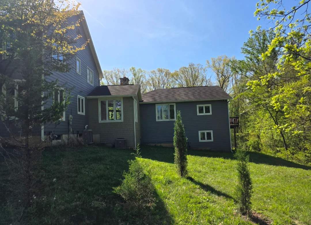 Two-story home with new dark gray asphalt shingle roof installation