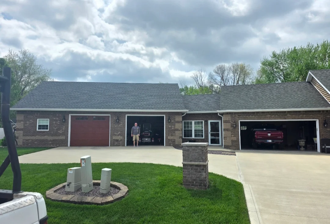 Brick home with new charcoal gray dimensional asphalt shingle roof installation